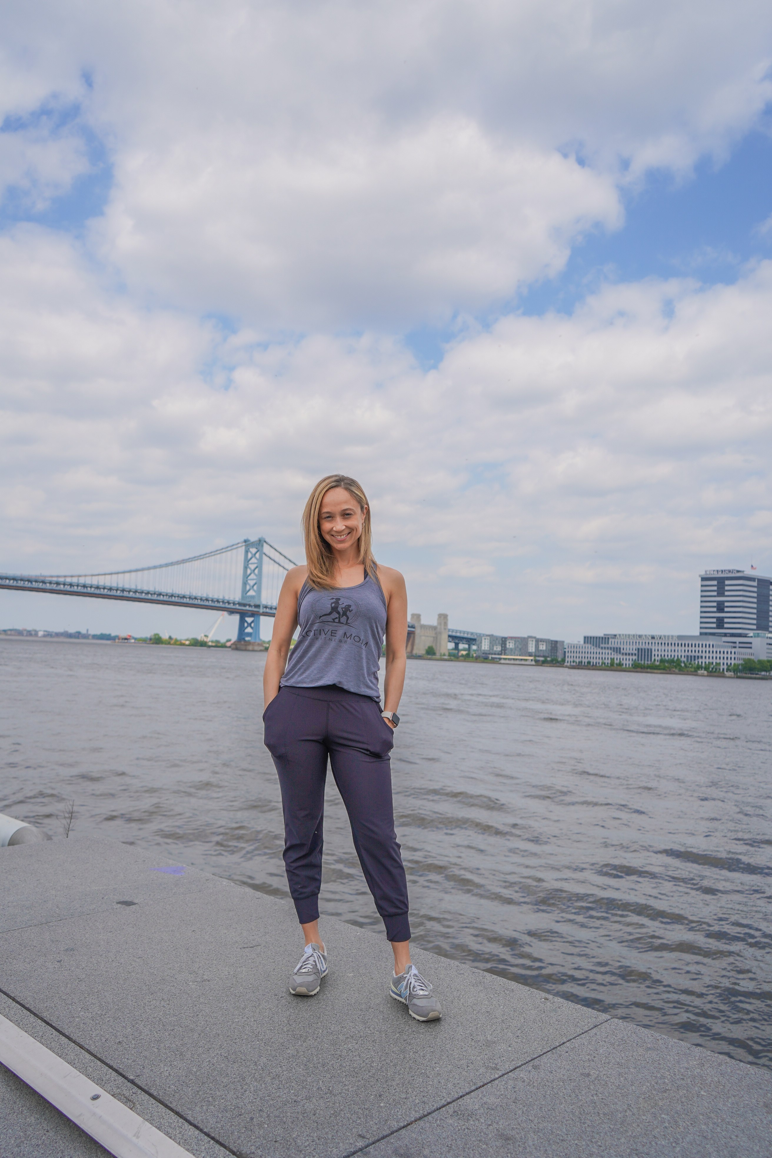 Ashley Reid with hands in pocket in Philadelphia by the river